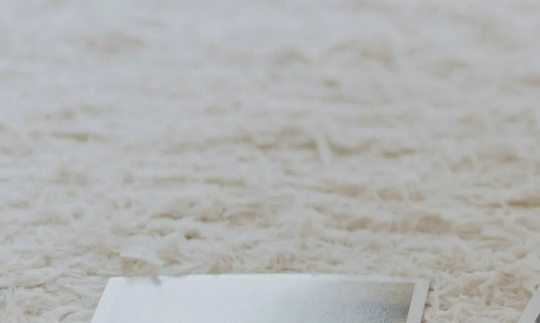 Close-up of a textured beige surface, possibly a sandy beach or a similar material.