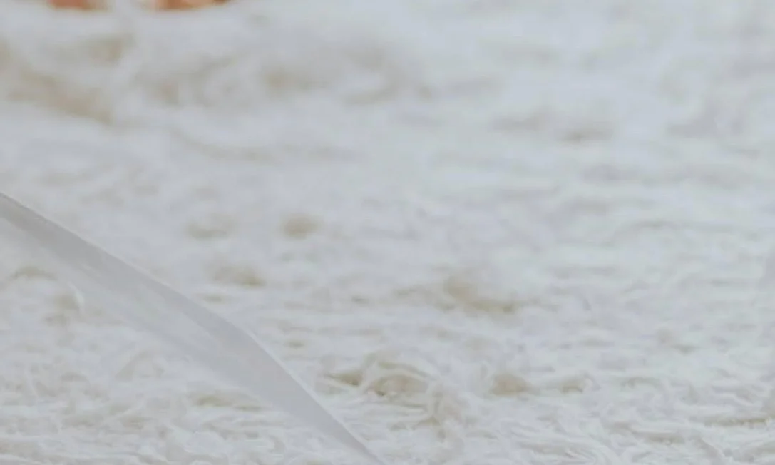 Water being poured onto a white, textured surface.