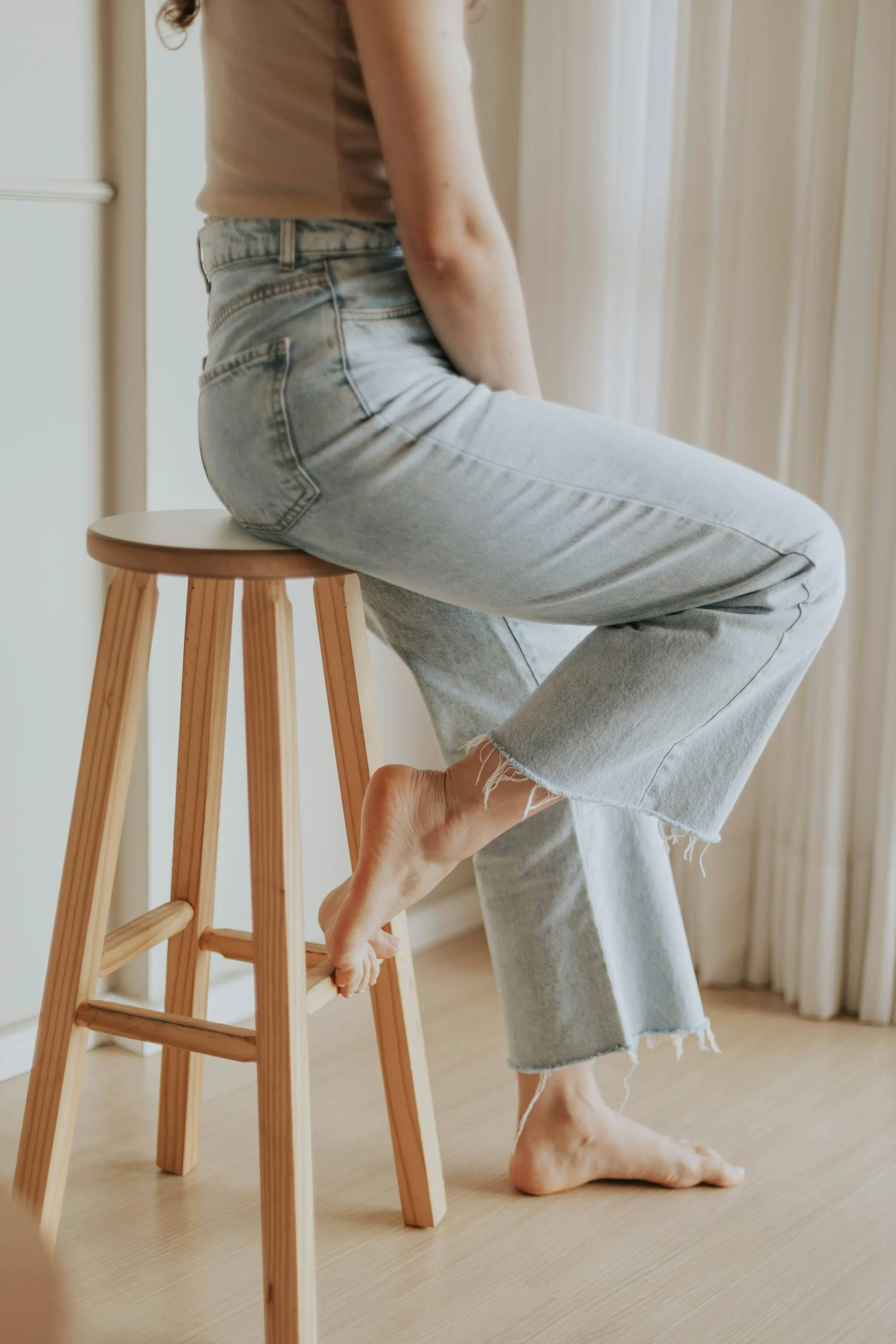 Woman sitting on a stool taking time to think or plan through her website layout