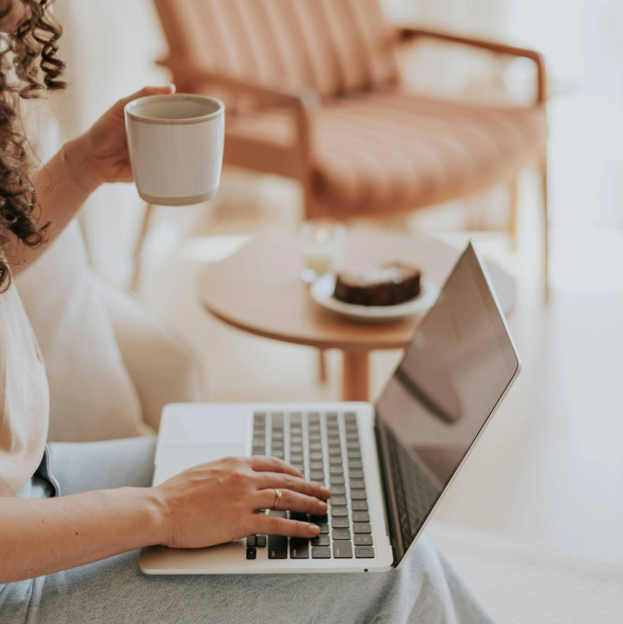 Business owner working on their website with coffee in a relaxed workspace