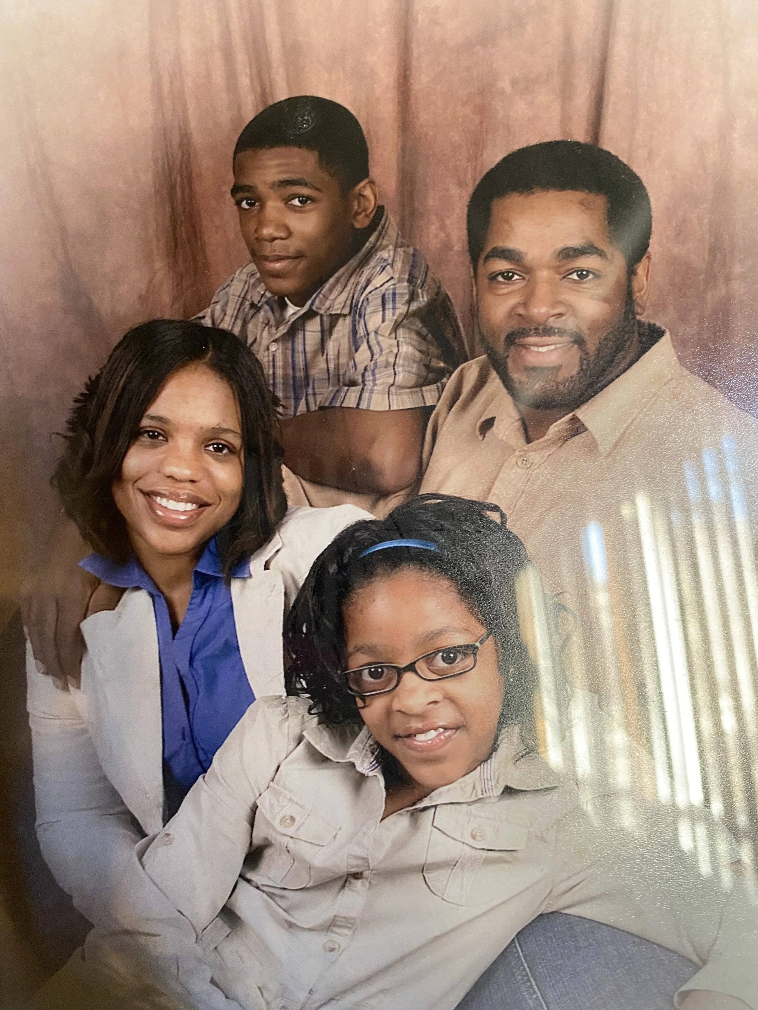 Corey in a family portrait with parents and sister