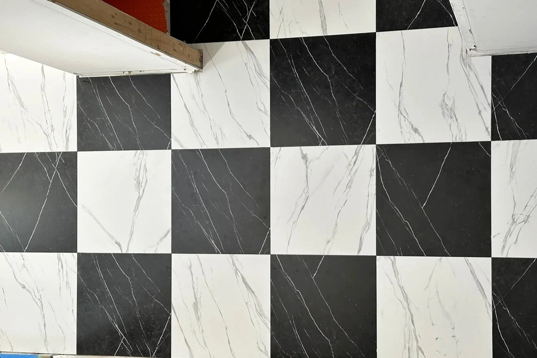 Black and white marble checkered tile floor measured meticulously.