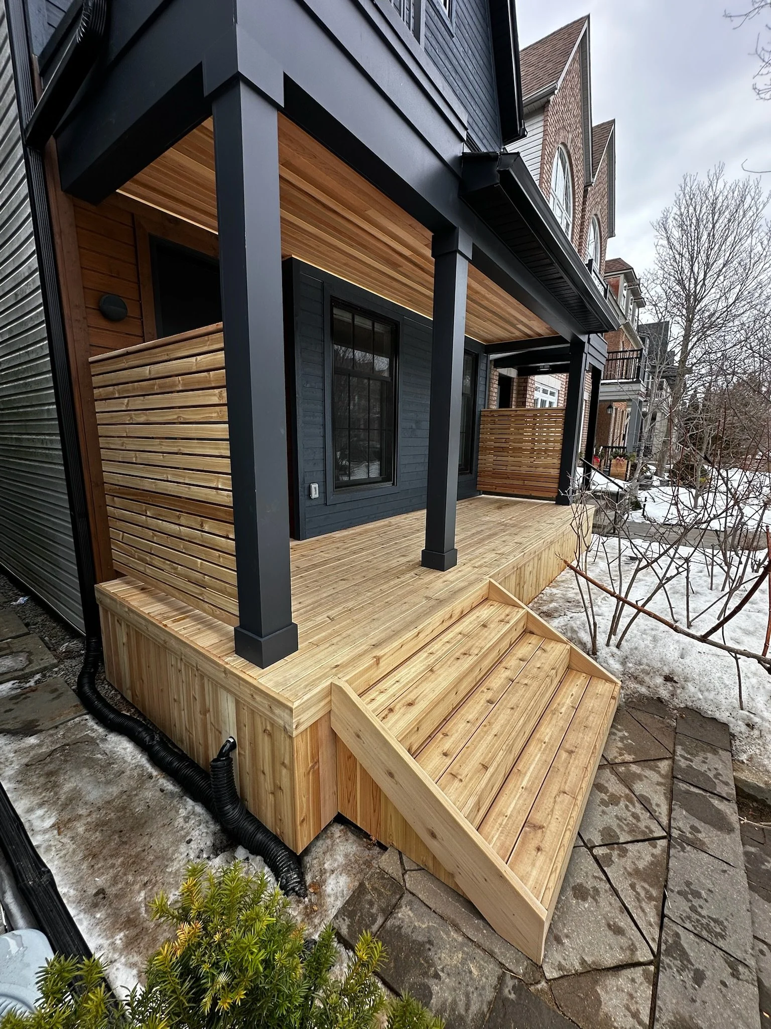Beautiful wood porch with wood panel ceiling and privacy wall