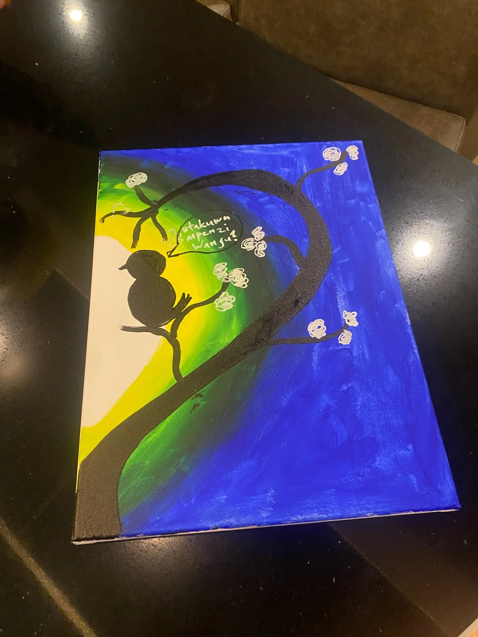 A colorful painting of a tree with white blossoms, set against a bright blue sky and a green and yellow ground.