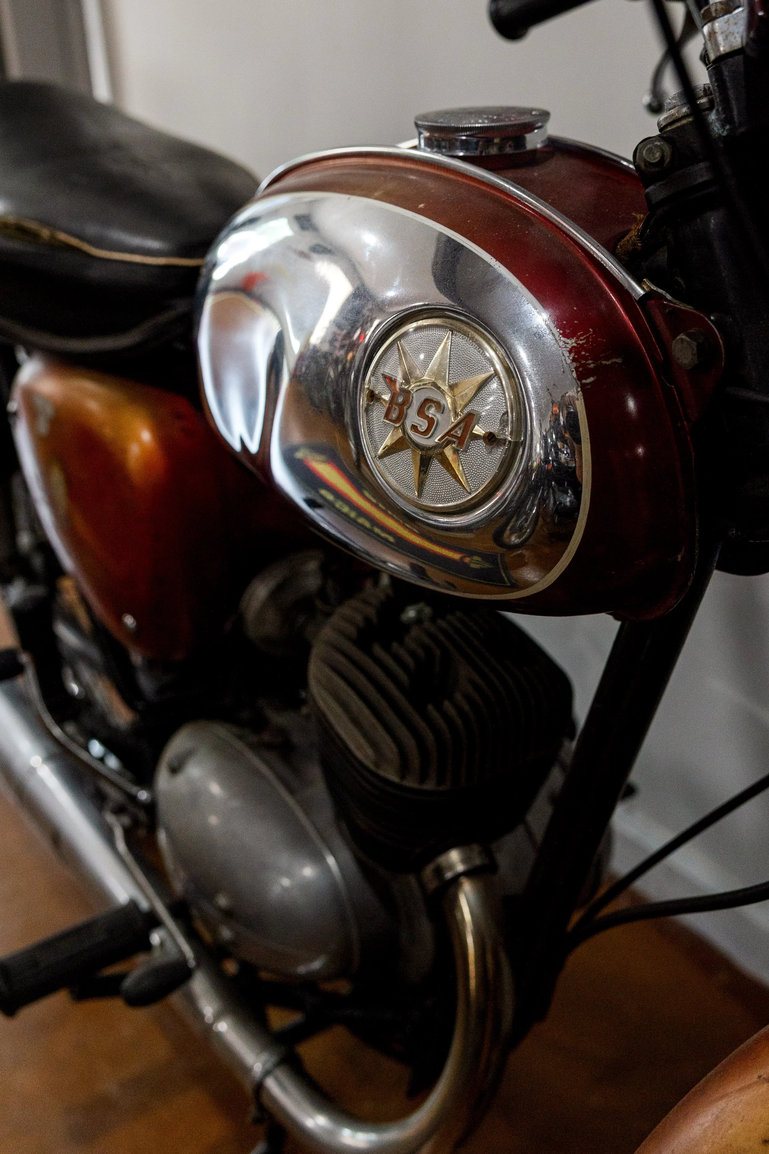 Close-up of a vintage BSA motorcycle engine with a red fuel tank and chrome accents. Vintage motorcycle collection on display at Birmingham Vintage Cycle in Birmingham Alabama