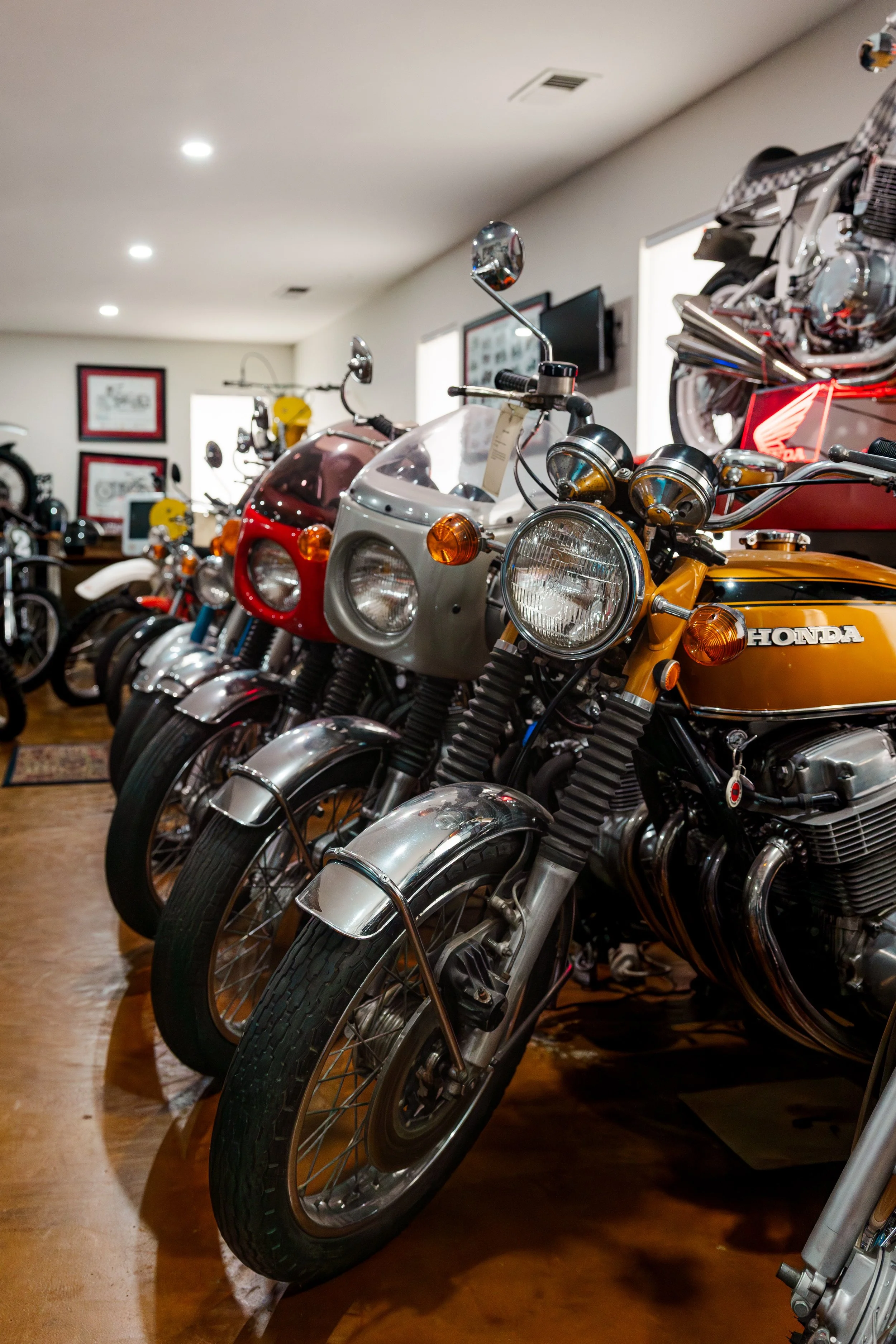 Row of vintage motorcycles on display in a showroom. Vintage motorcycle collection on display at Birmingham Vintage Cycle in Birmingham Alabama