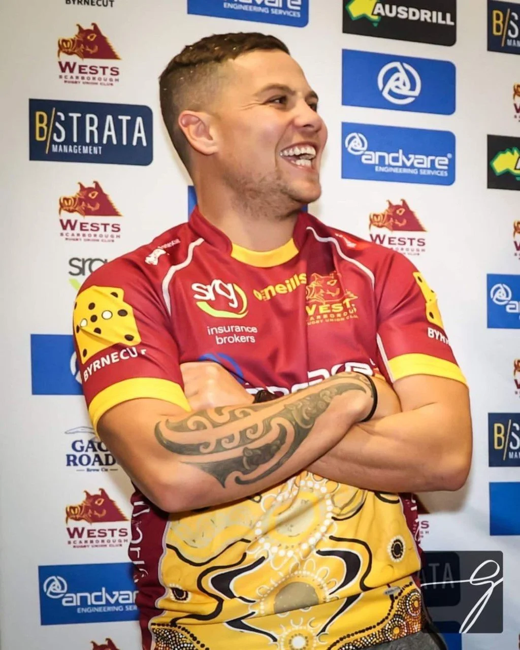 Wests Scarborough premier grade player in front of a club sponsor backdrop
