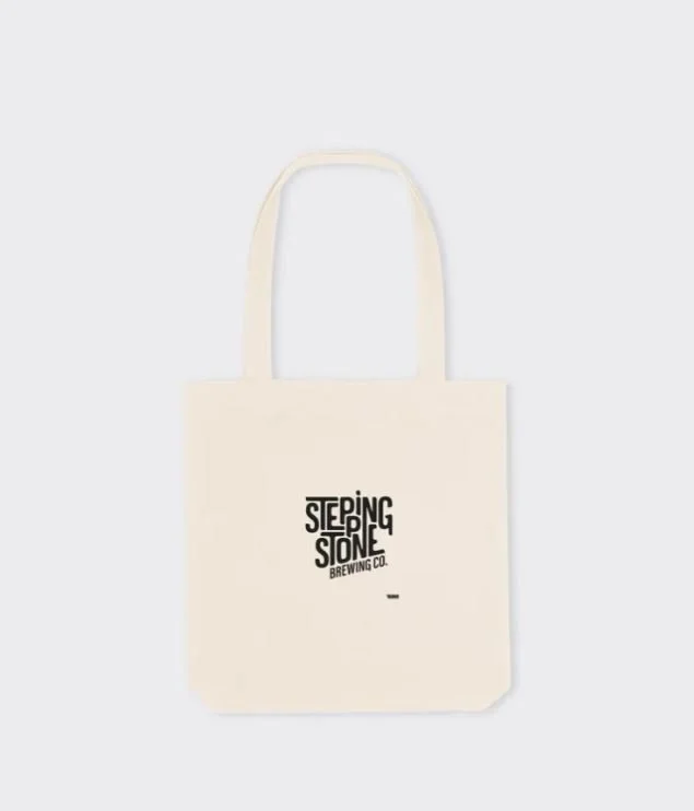 Cream-colored tote bag with 'Stepping Stone Brewing Co.' logo in black text