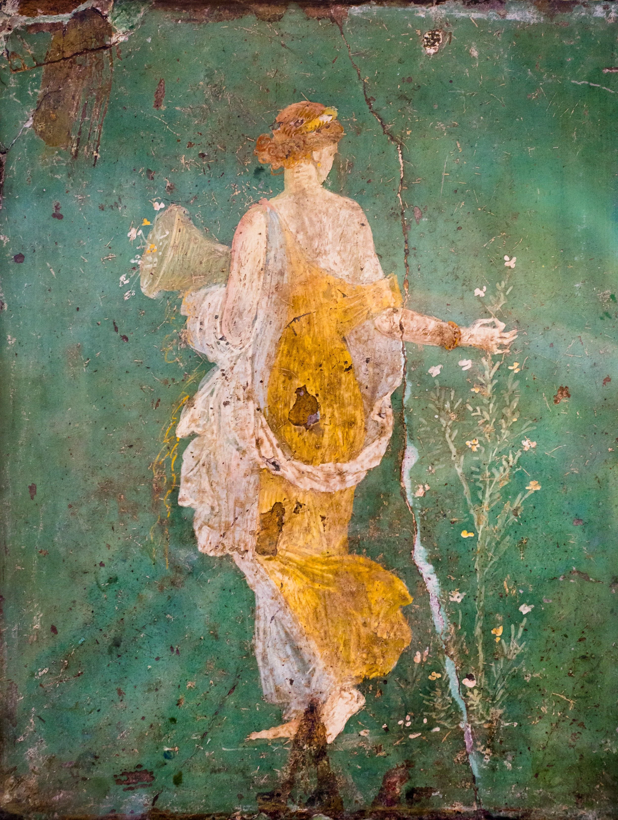 A vintage painting of a woman dressed in yellow with a white shawl, holding a branch with flowers, set against a weathered green background.