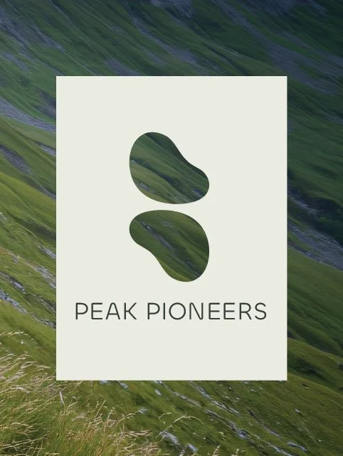 A logo featuring two abstract green mountain shapes with the words 'Peak Pioneers' below, set against a background of a green hilly landscape.