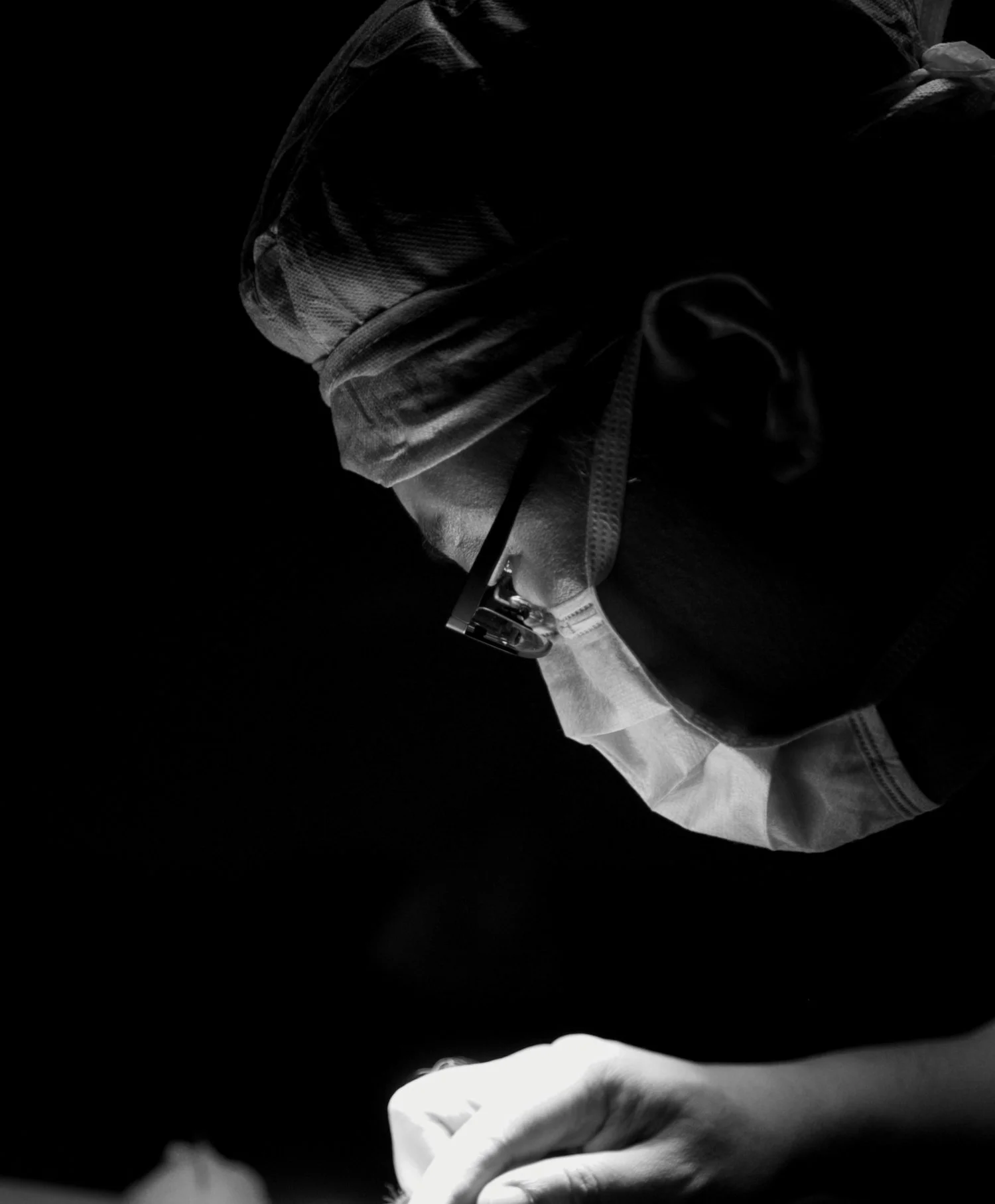 Photo of Dr. Christopher Yu in operating theatre performing surgery