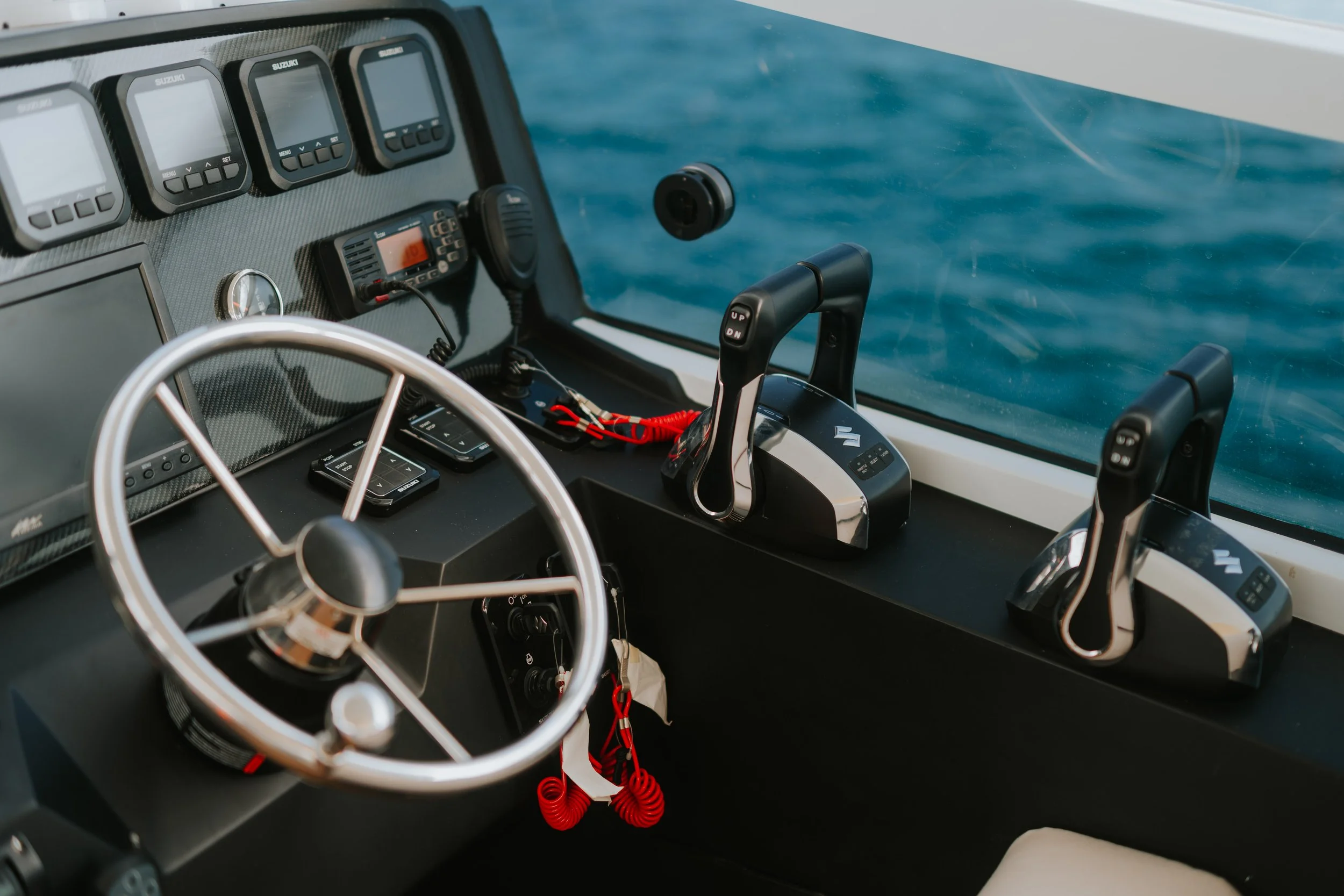 Captain's helm station and navigation controls aboard the Kalm Charters.