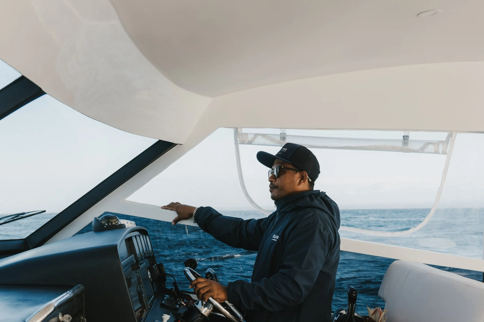 Kalm Charters captain navigating the vessel during a private charter.