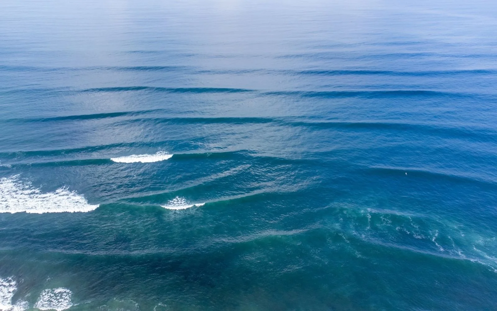 Open ocean water with small waves and ripples.