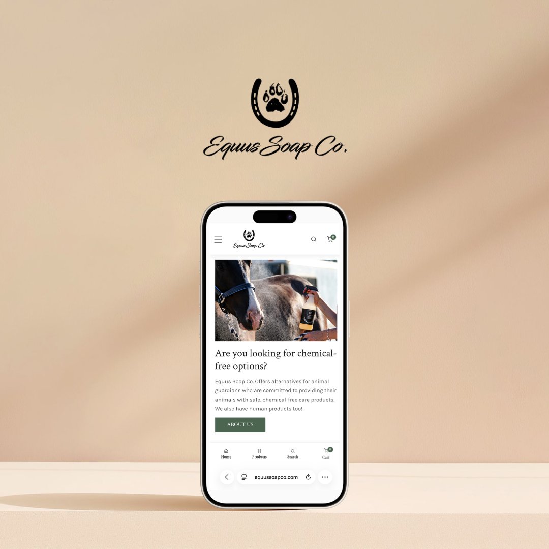 A smartphone on a beige surface displaying the web page of Equus Soap Co., which offers chemical-free products for animals and humans. Behind the phone is a blurred beige background with the company's logo and name.