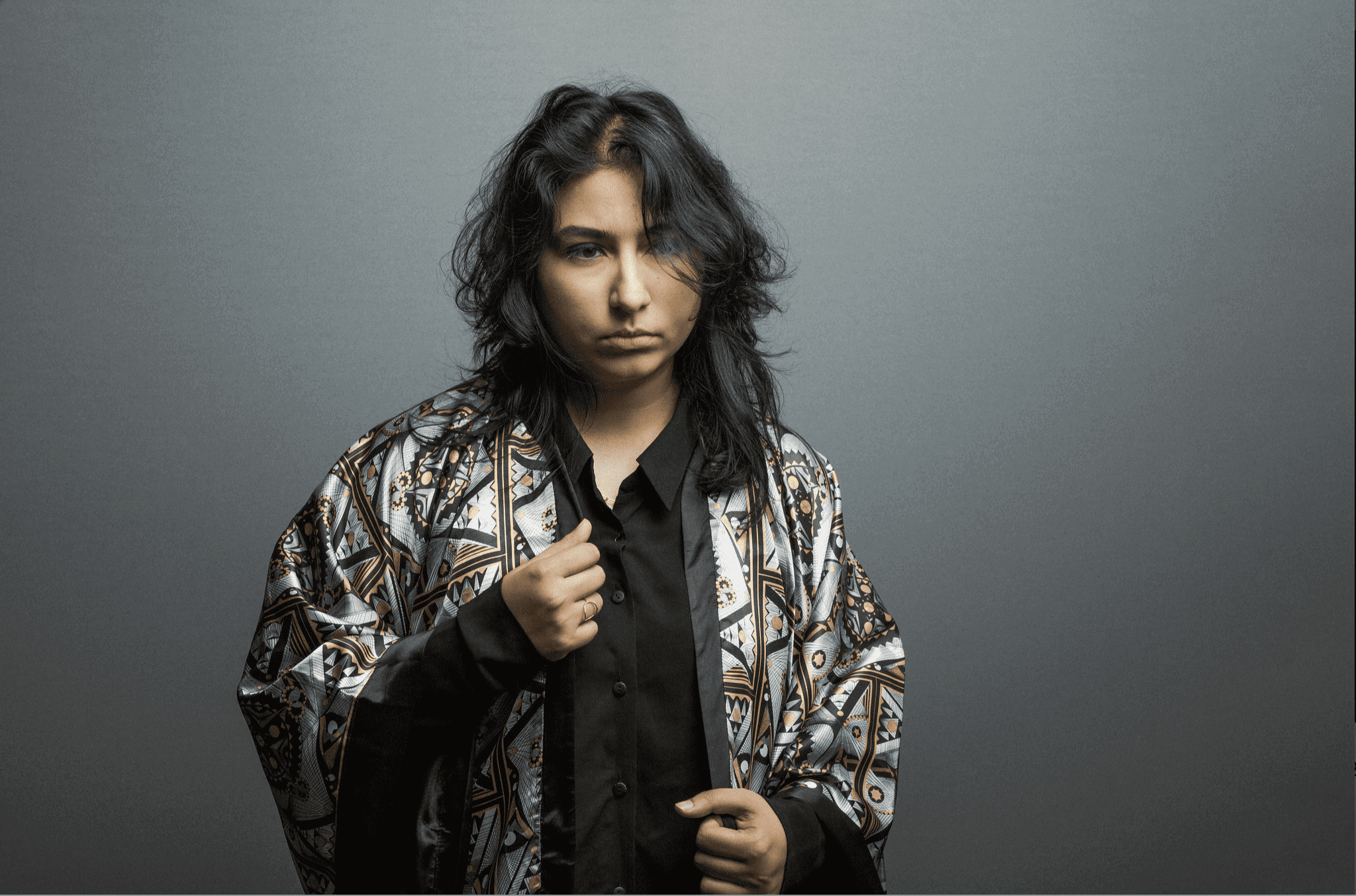 Photograph of musician Arooj Aftab wearing a garment made of the fabric designed by Zahyr Lauren. 
