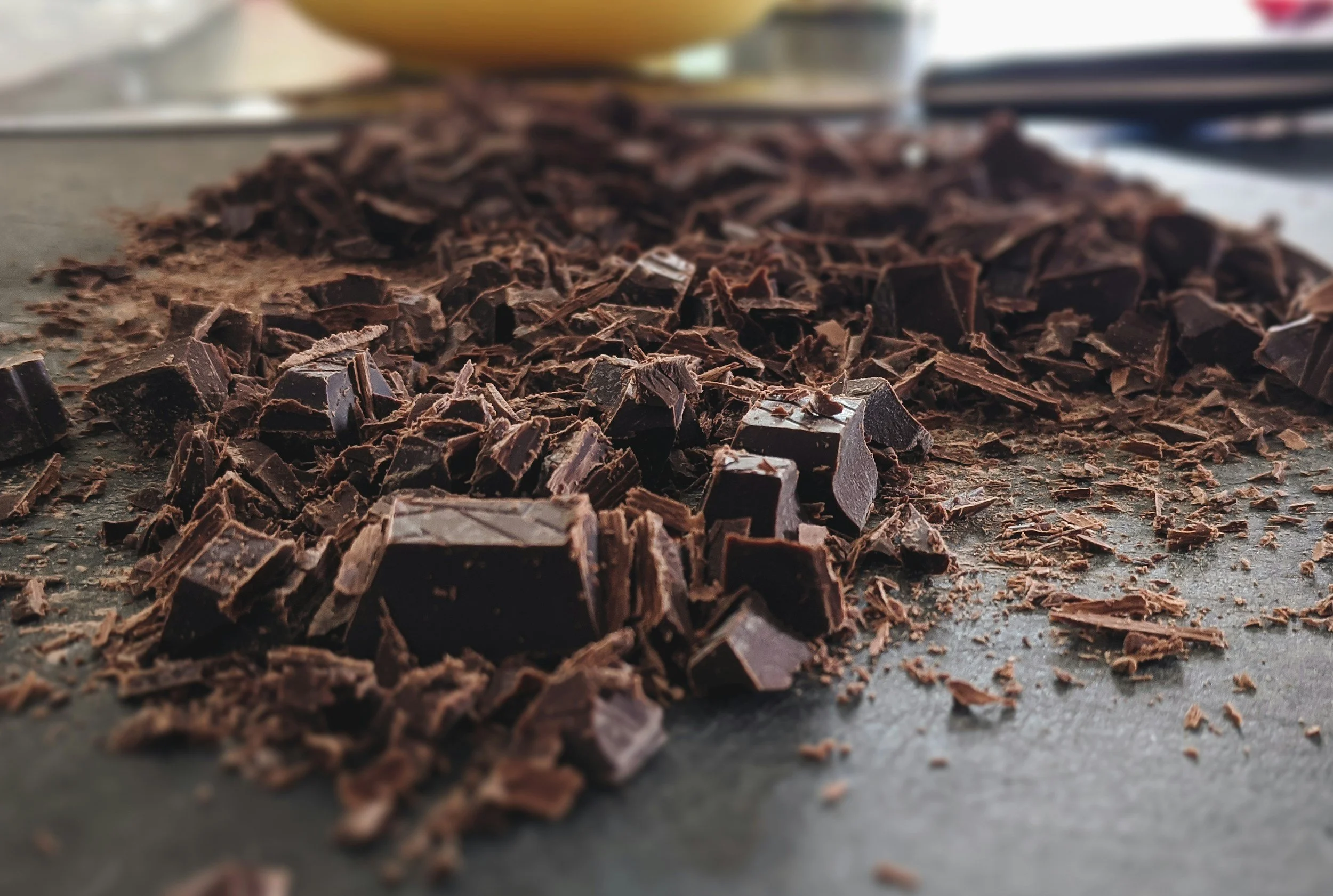 Close-up of chopped dark chocolate pieces on a baking sheet.