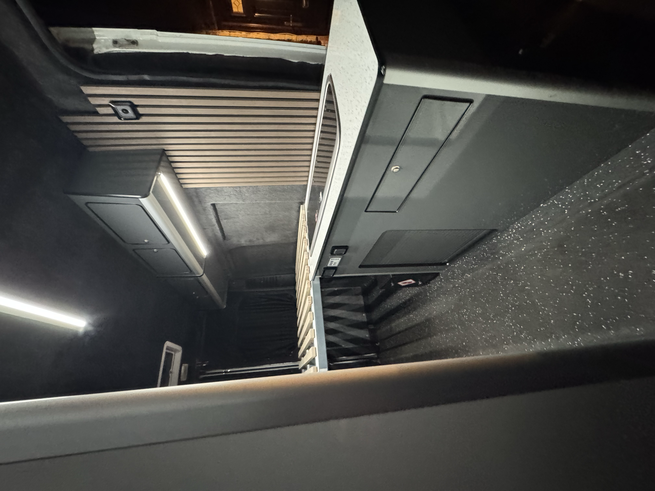Highly usable kitchen, fridge, overhead lockers, stylish acoustic panel finish, full width bed.