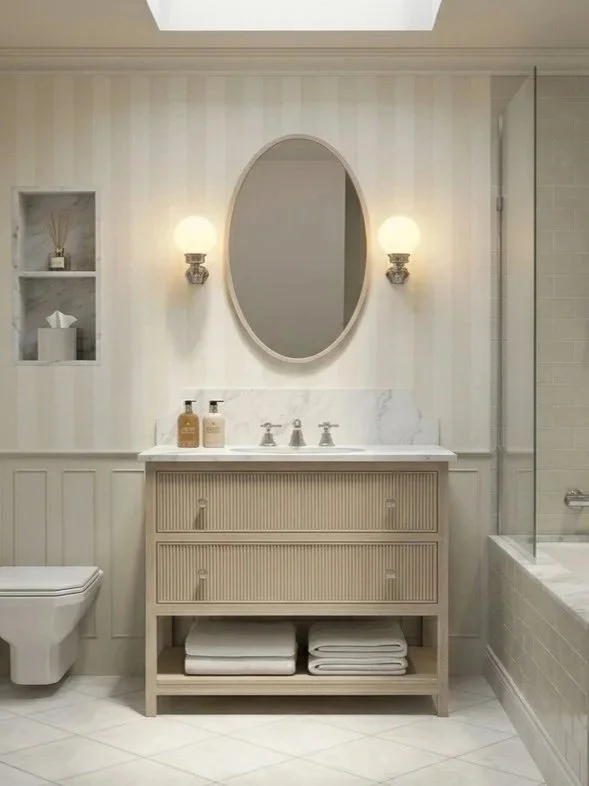 Rendering of a traditional English bathroom design study, with a vanity, oval mirror and wall lights
