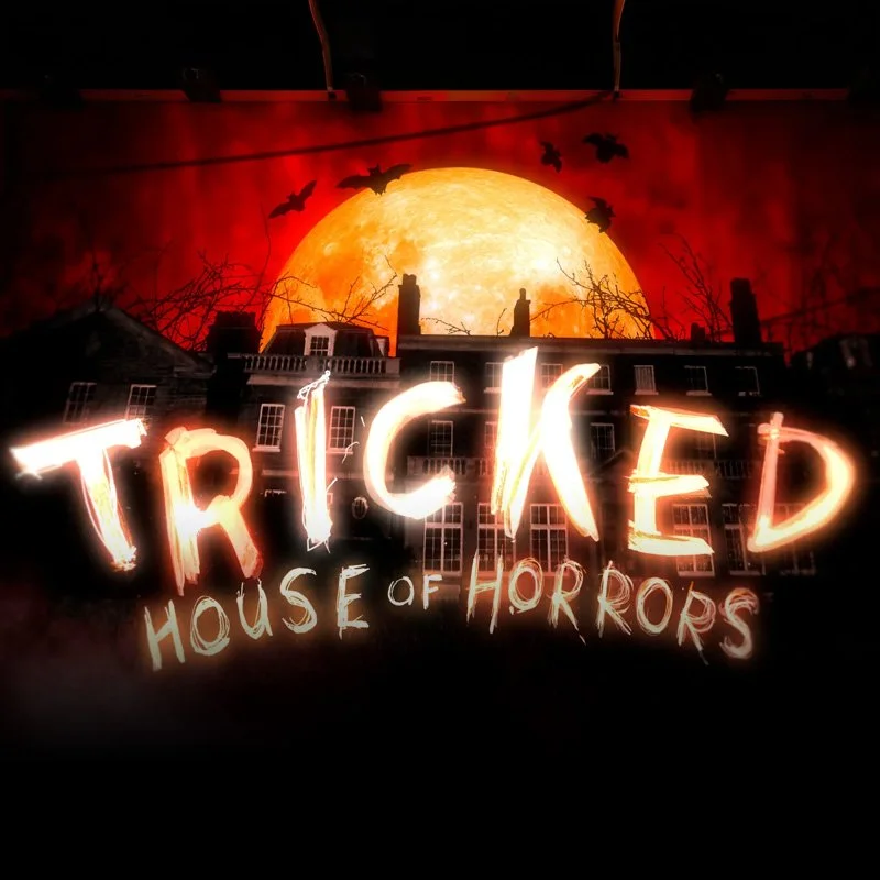 A spooky Halloween scene with a large full moon, black bats flying, ghostly house in the background, and glowing text reading 'Tricked House of Horrors'.