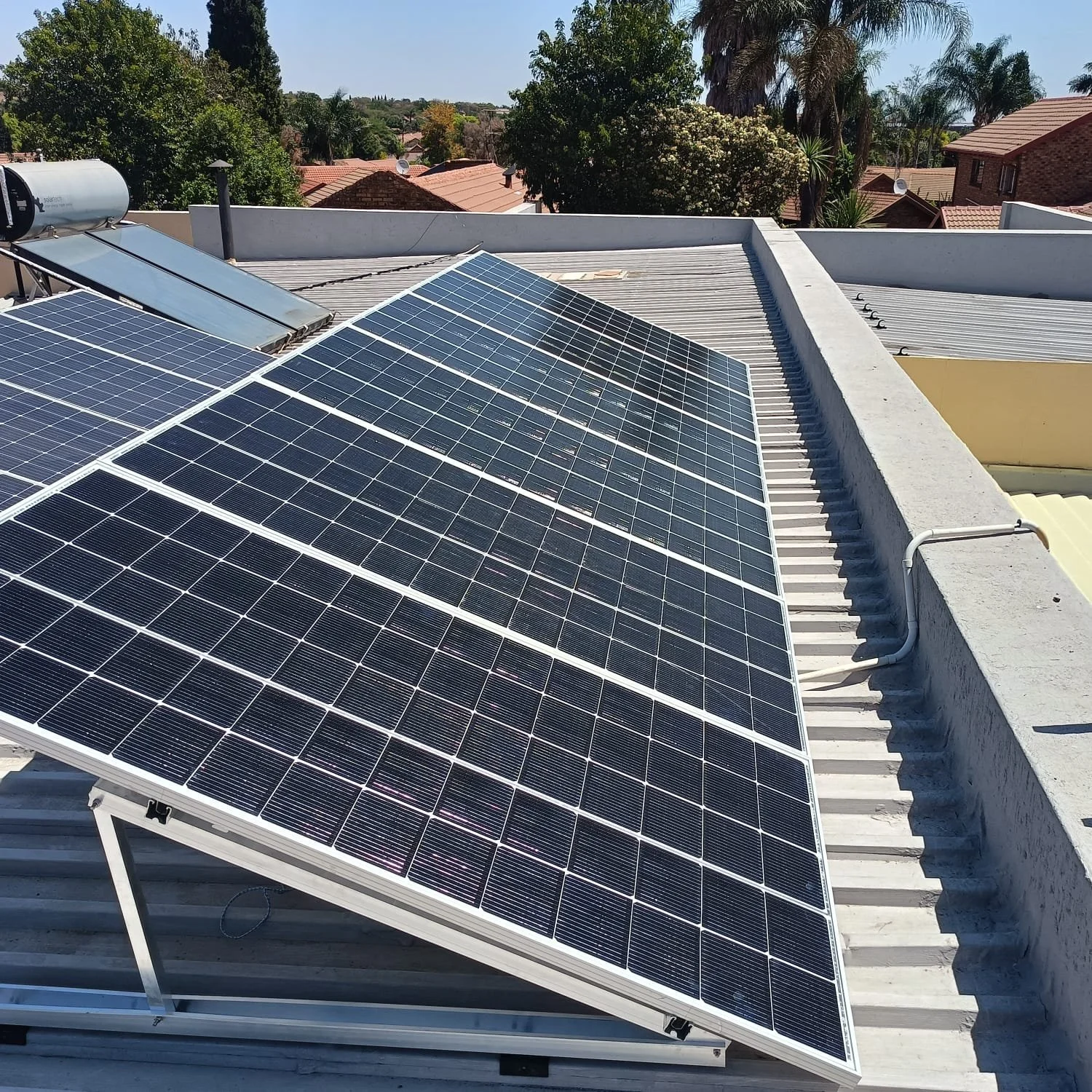 Solar panels installed on a rooftop under a clear sky.
