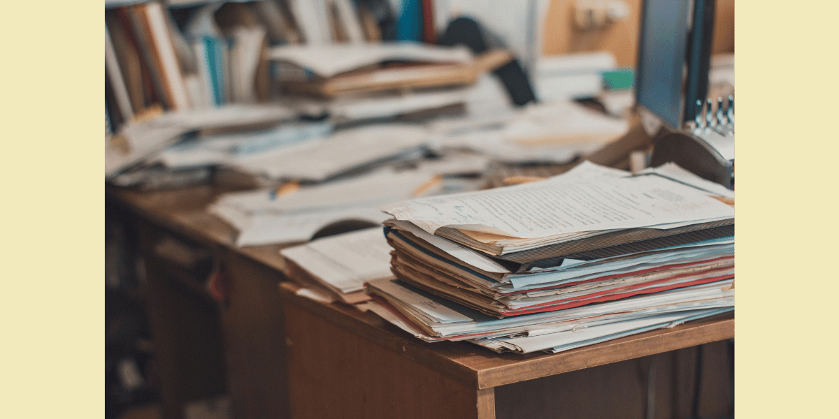 A busy educators desk, reflecting the overwhelming responsibility