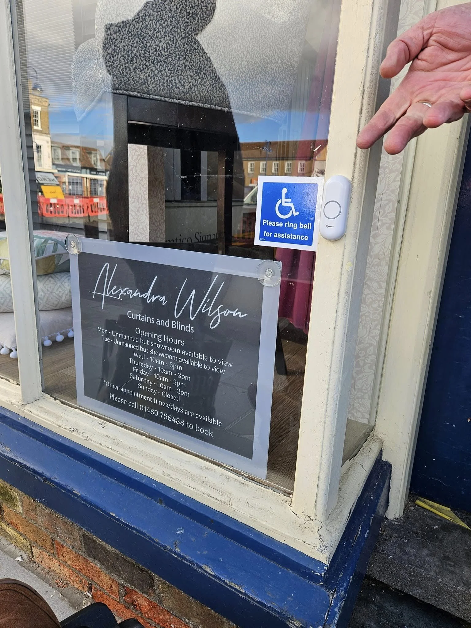 A doorbell and sign for Floored by Ian