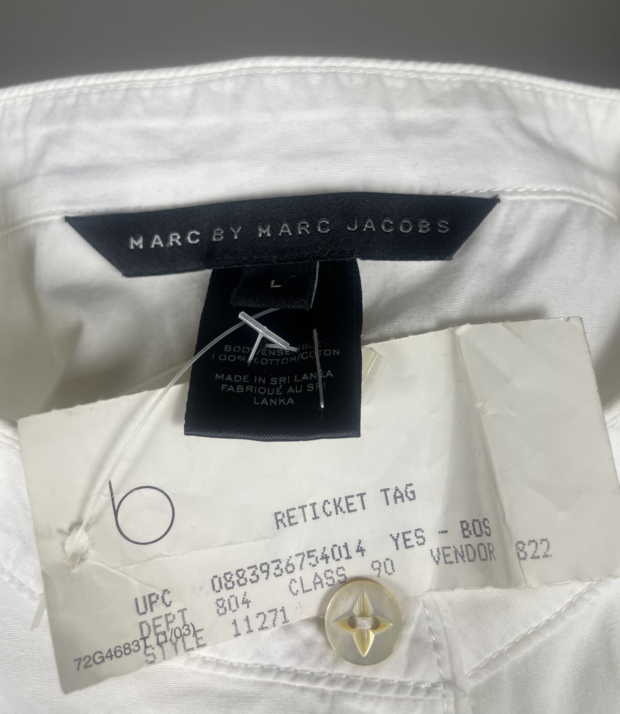 Interior reticket store‑sample tag and MBMJ label photographed clearly for authenticity and production context.