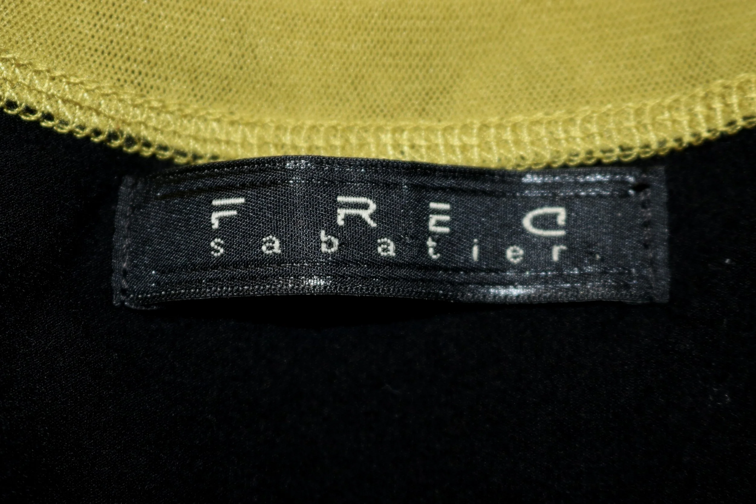 black tag with white print stating Fred Sabatier
