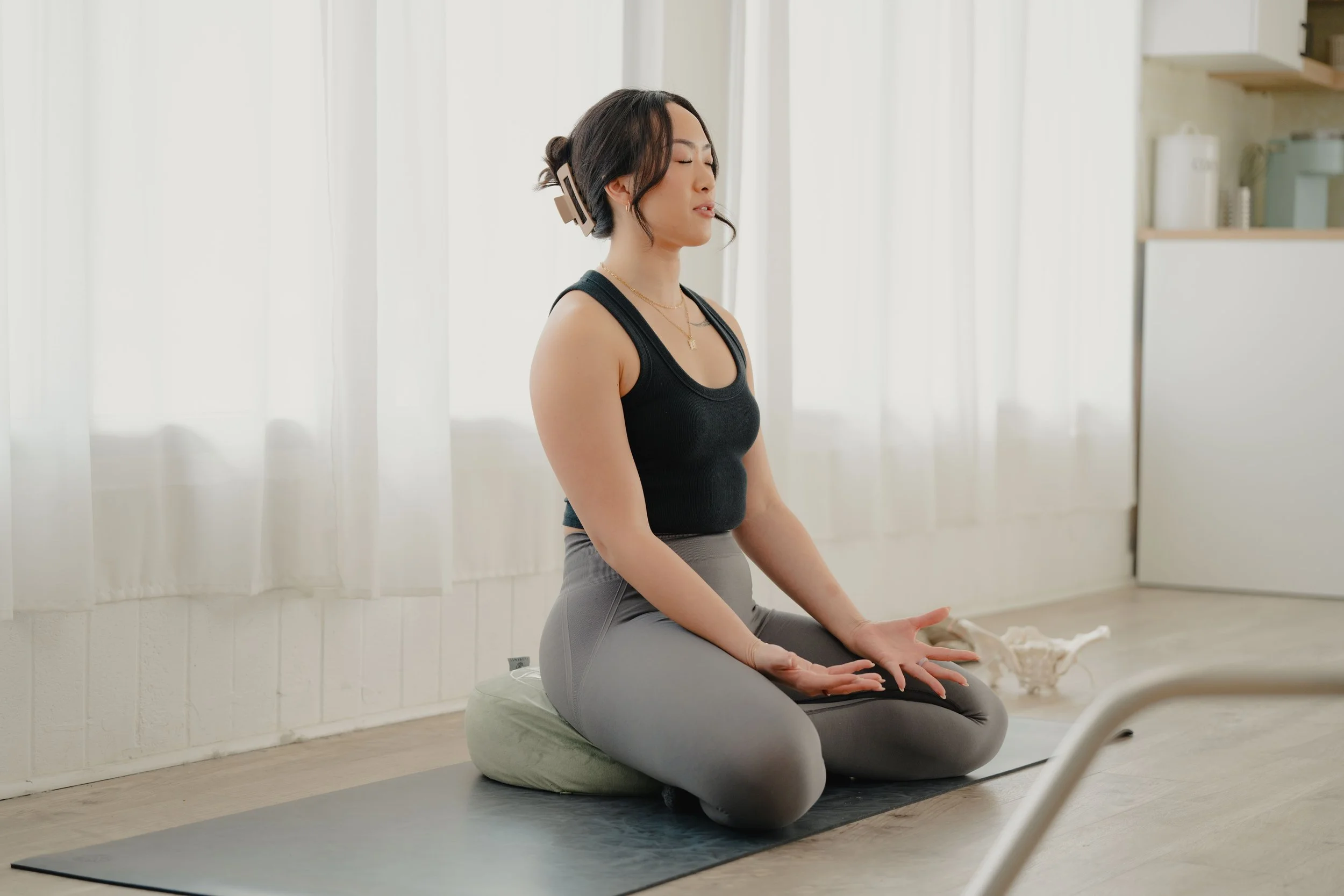 Jamee Leann Vasquez sits on a mat during a postnatal yoga session in San Jose.