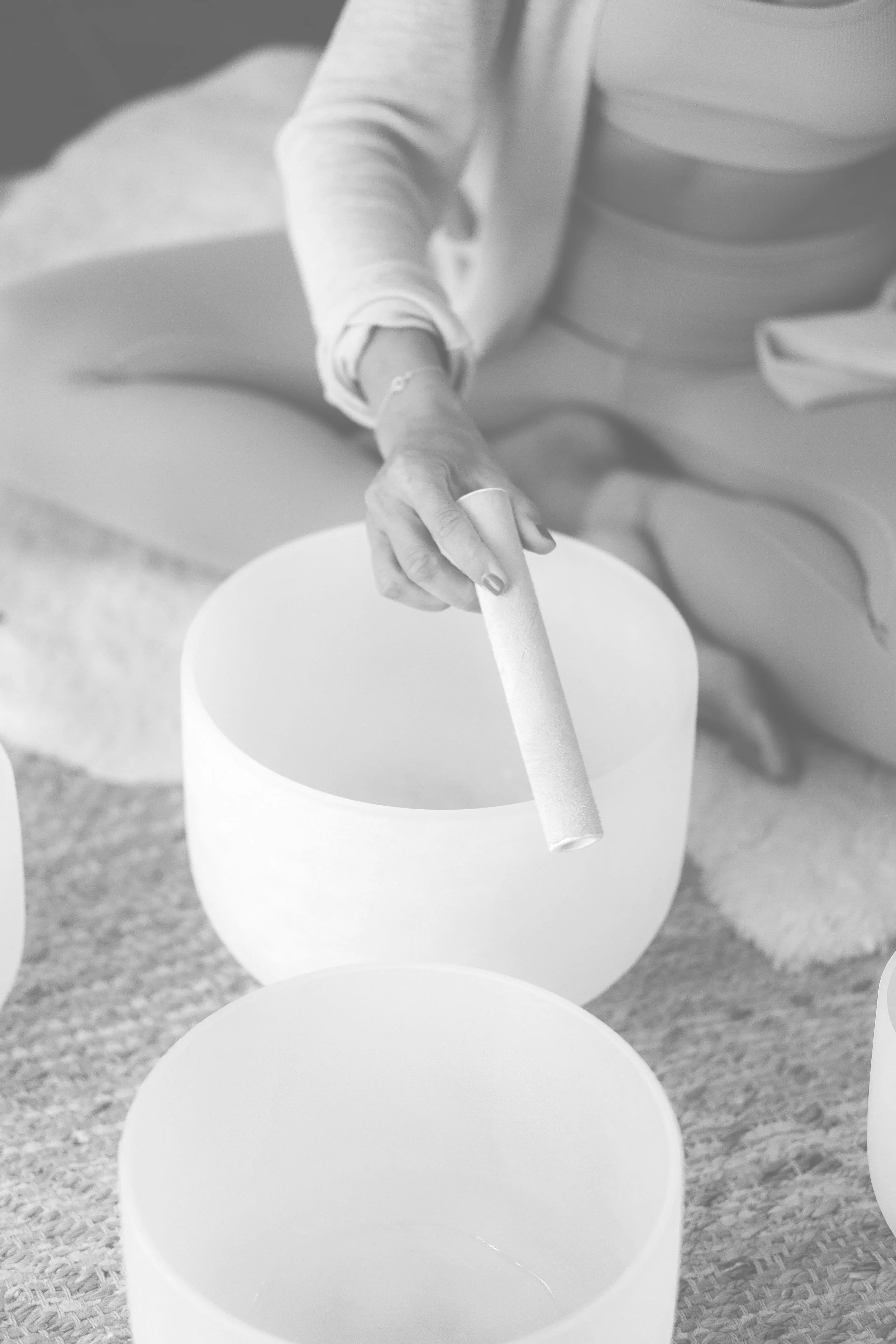 Jamee Leann Vasquez plays sound bath bowls during a restorative reiki session.