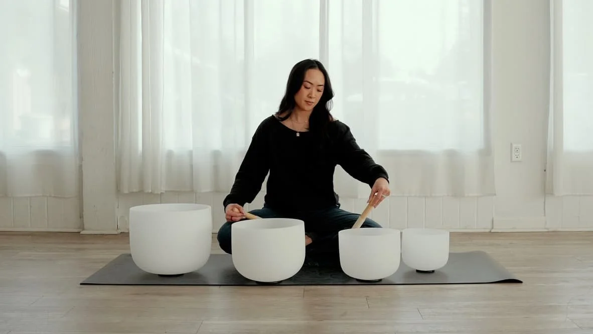 Jamee Leann Vasquez plays musical bowls during a sound healing session in San Jose, California