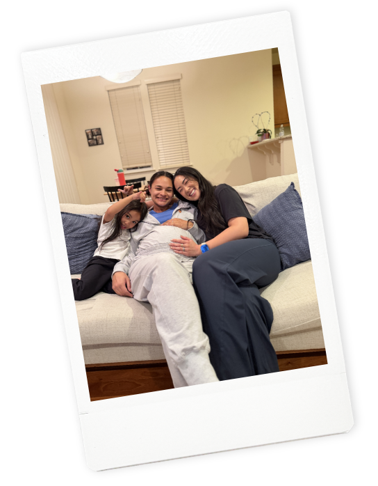 A pregnant mom and young daughter smile with Jamee Leann Vasquez, their overnight postpartum doula in Willow Glen, California.
