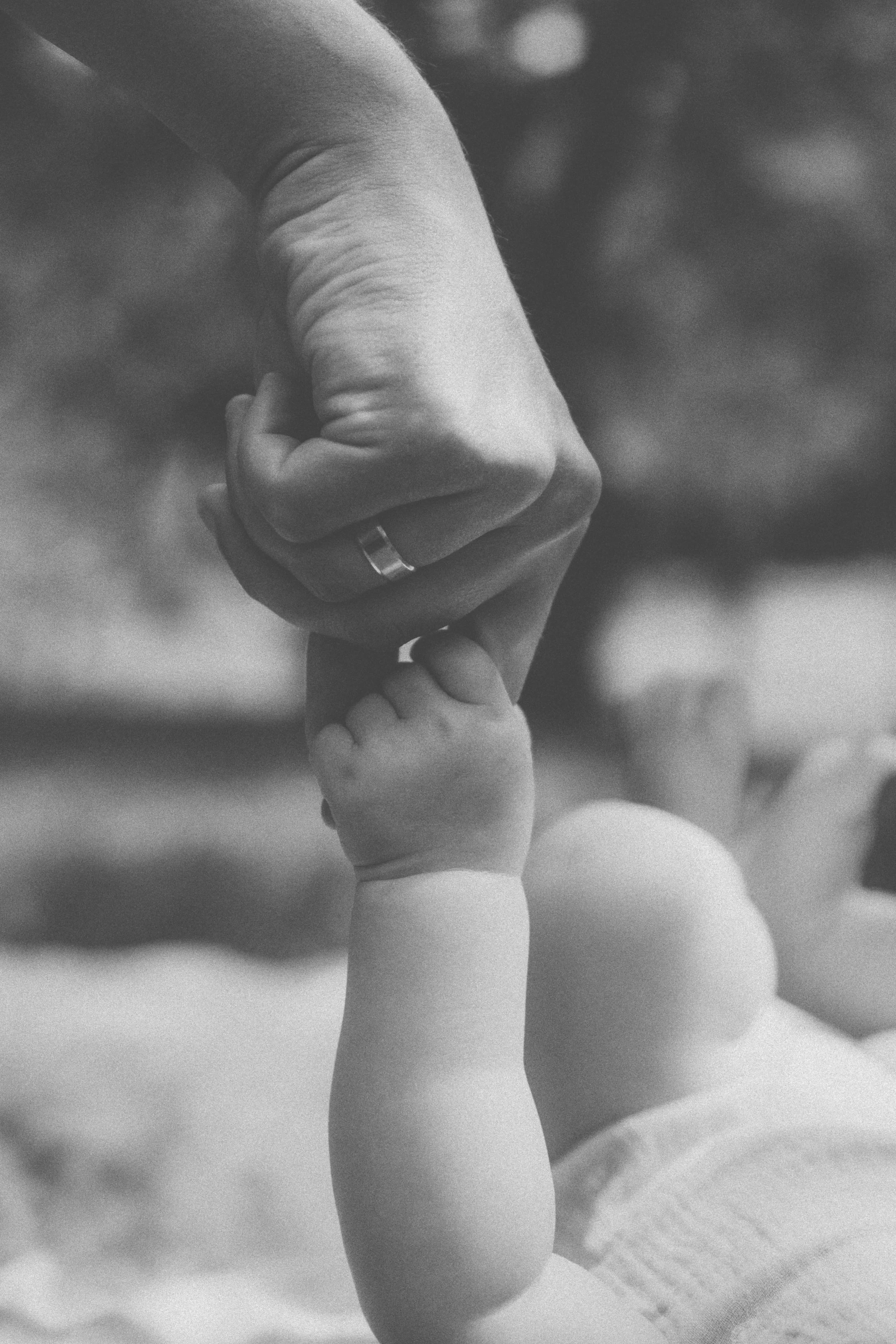 A Flourish & Flow birth doula client holds their newborn's hand in Willow Glen, California.
