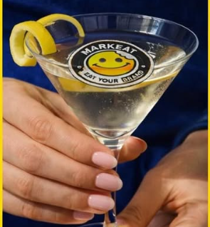 Un cocktail brandizzato da una cialdina alimentare con un'emoji sorridente e la scritta 'Marketat' e 'Eat your drinks'.