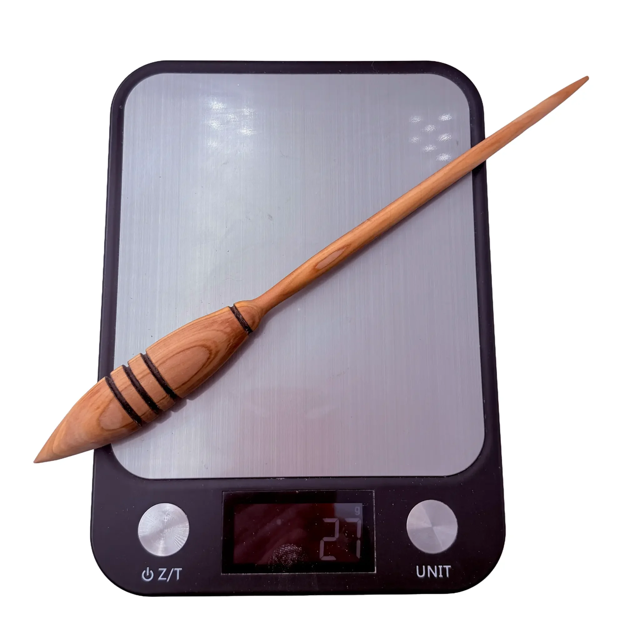 Digital scale showing the exact weight of the handcrafted Austrian juniper support spindle at approximately 27 grams.