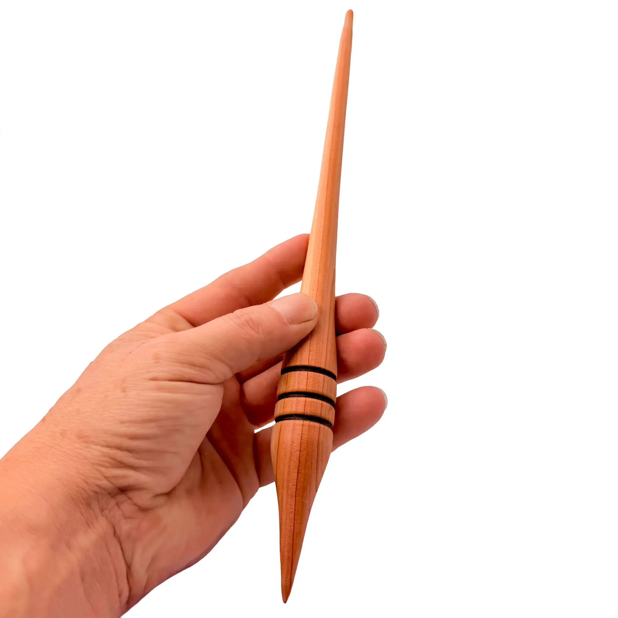 Hand holding an Austrian juniper support spindle designed for supported spinning and fine yarns.