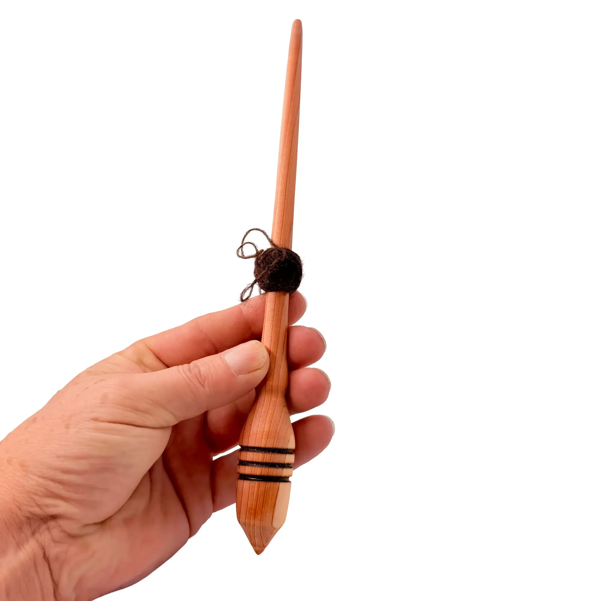 Hand holding an Austrian juniper support spindle designed for smooth supported spinning.