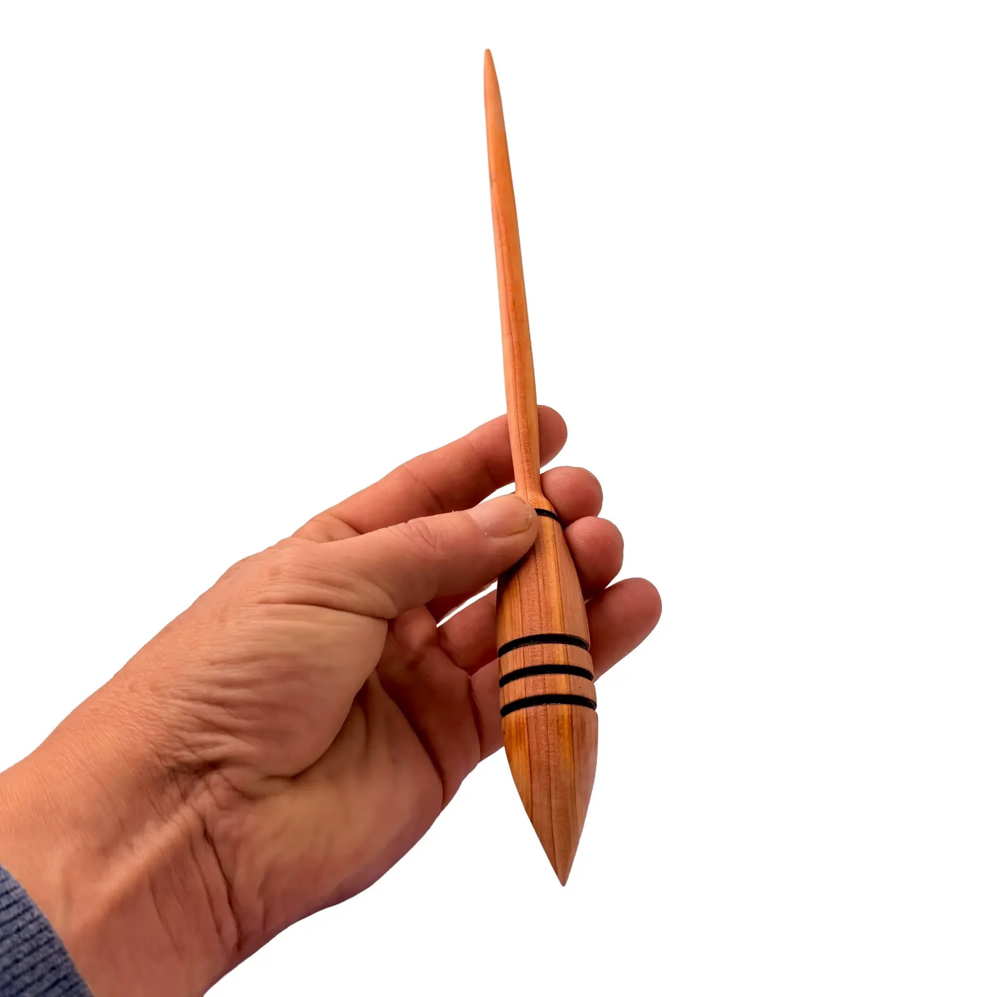 Austrian juniper support spindle shown in hand to demonstrate size, balance and handling.
