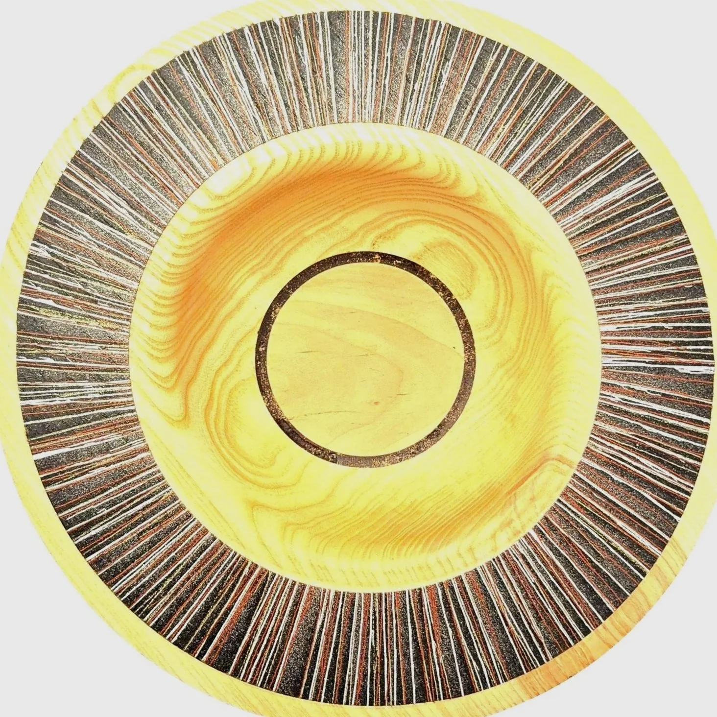 Materialdetail eines handgedrechselten Schmucktellers aus Esche und Birne mit sichtbar feiner Holzmaserung