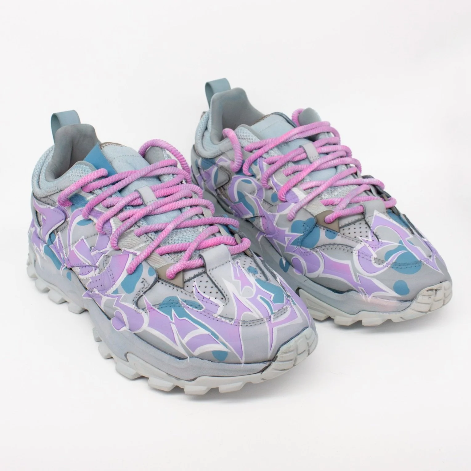 Gray and purple wild-style patterned sneakers with pink laces.