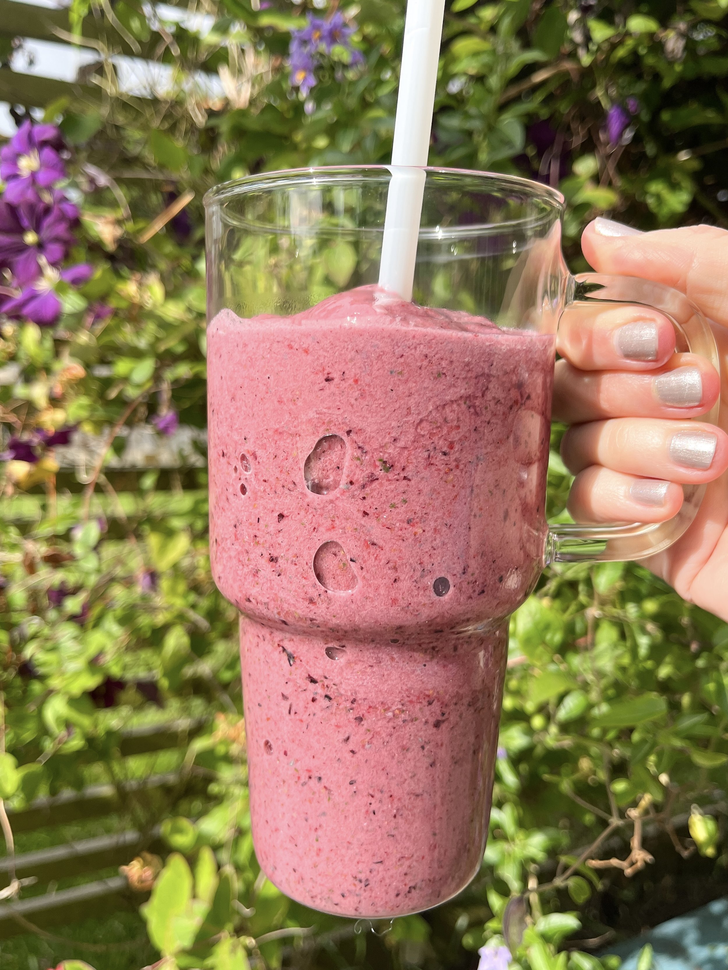An image of a strawberrie slushie smoothie in a glass with a straw