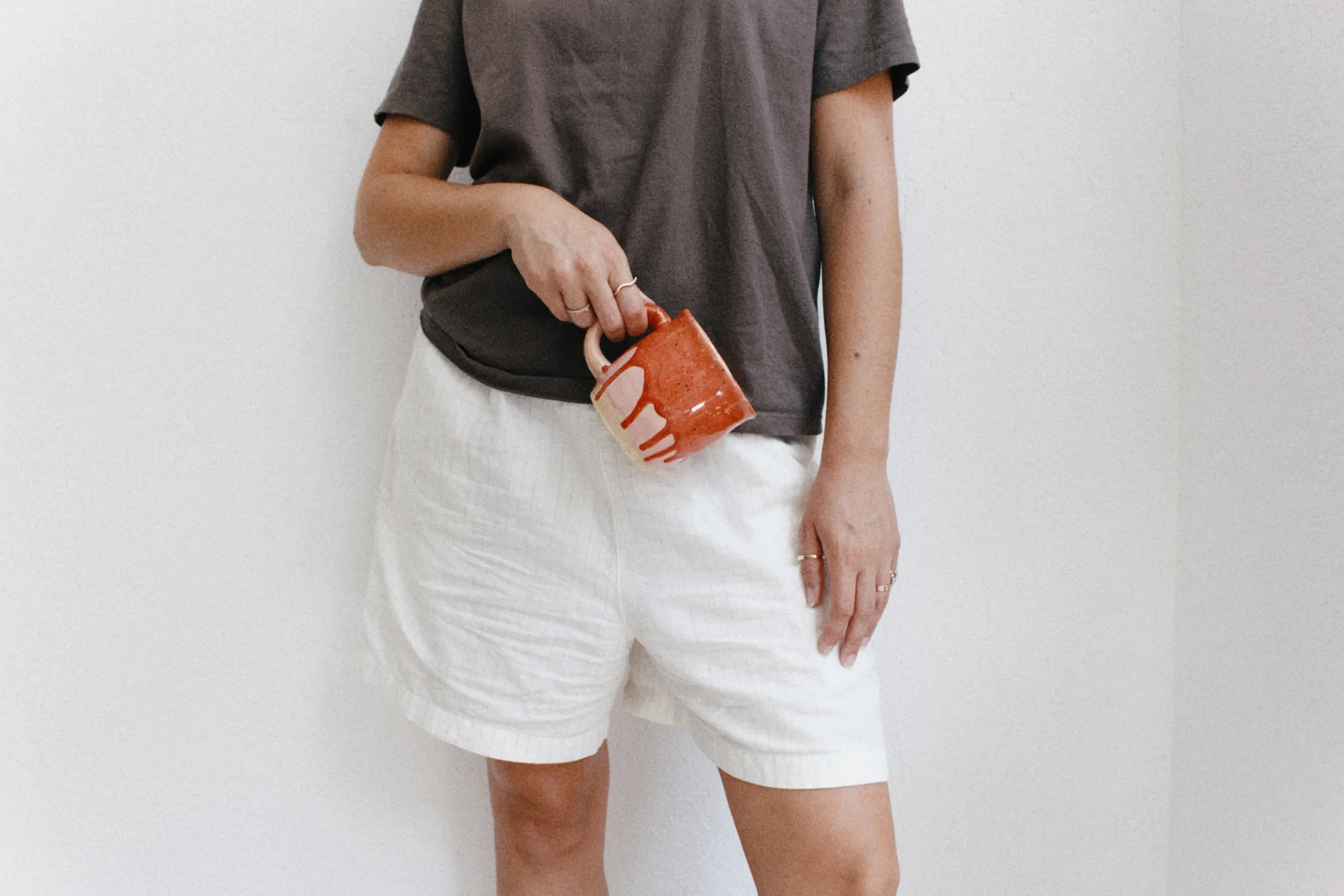 marti-ceramic-studio-model-holding-ceramic-mug.webp