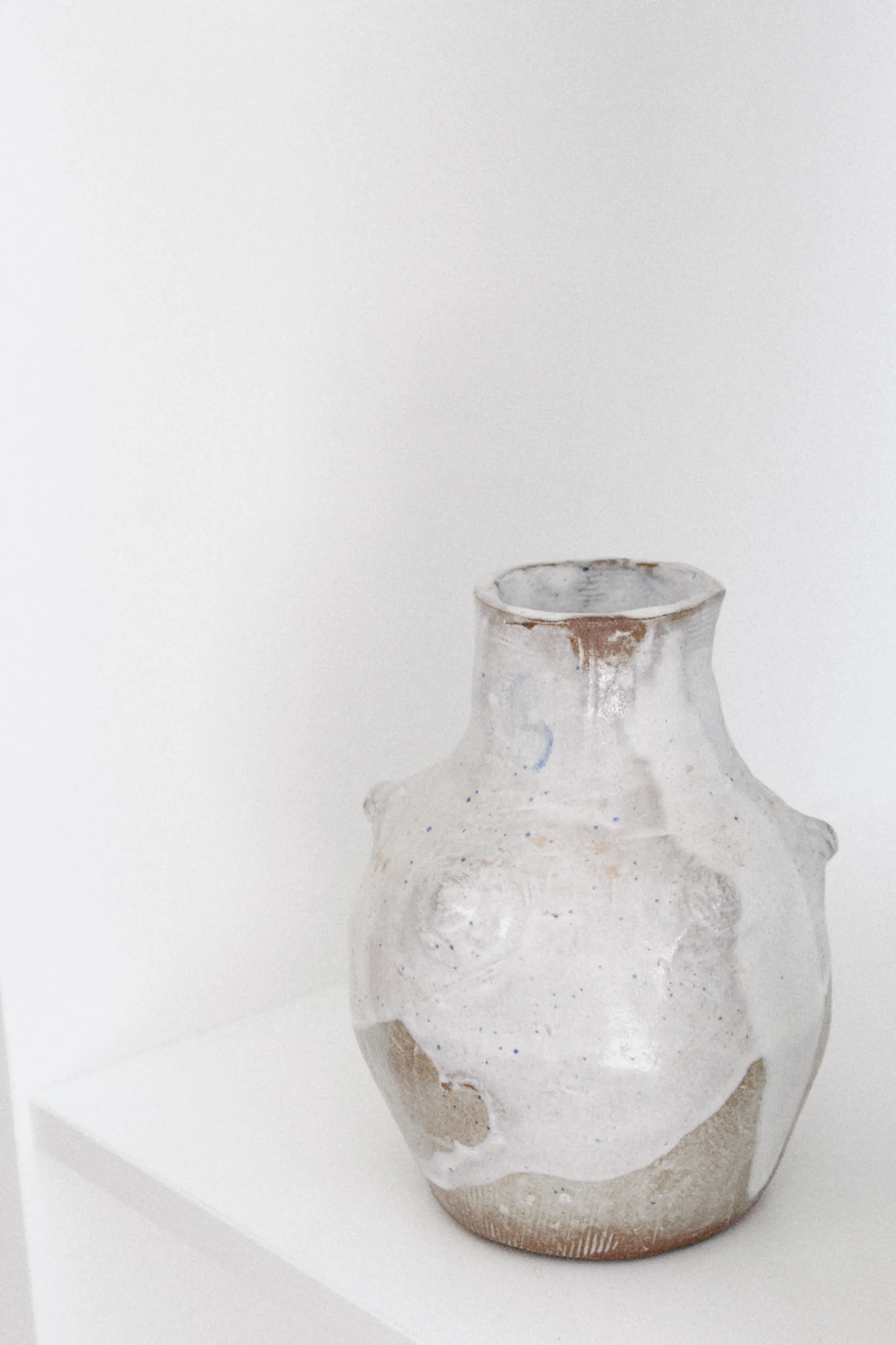 Handmade white ceramic vase displayed in a minimalist studio environment for Marti Ceramic Studio