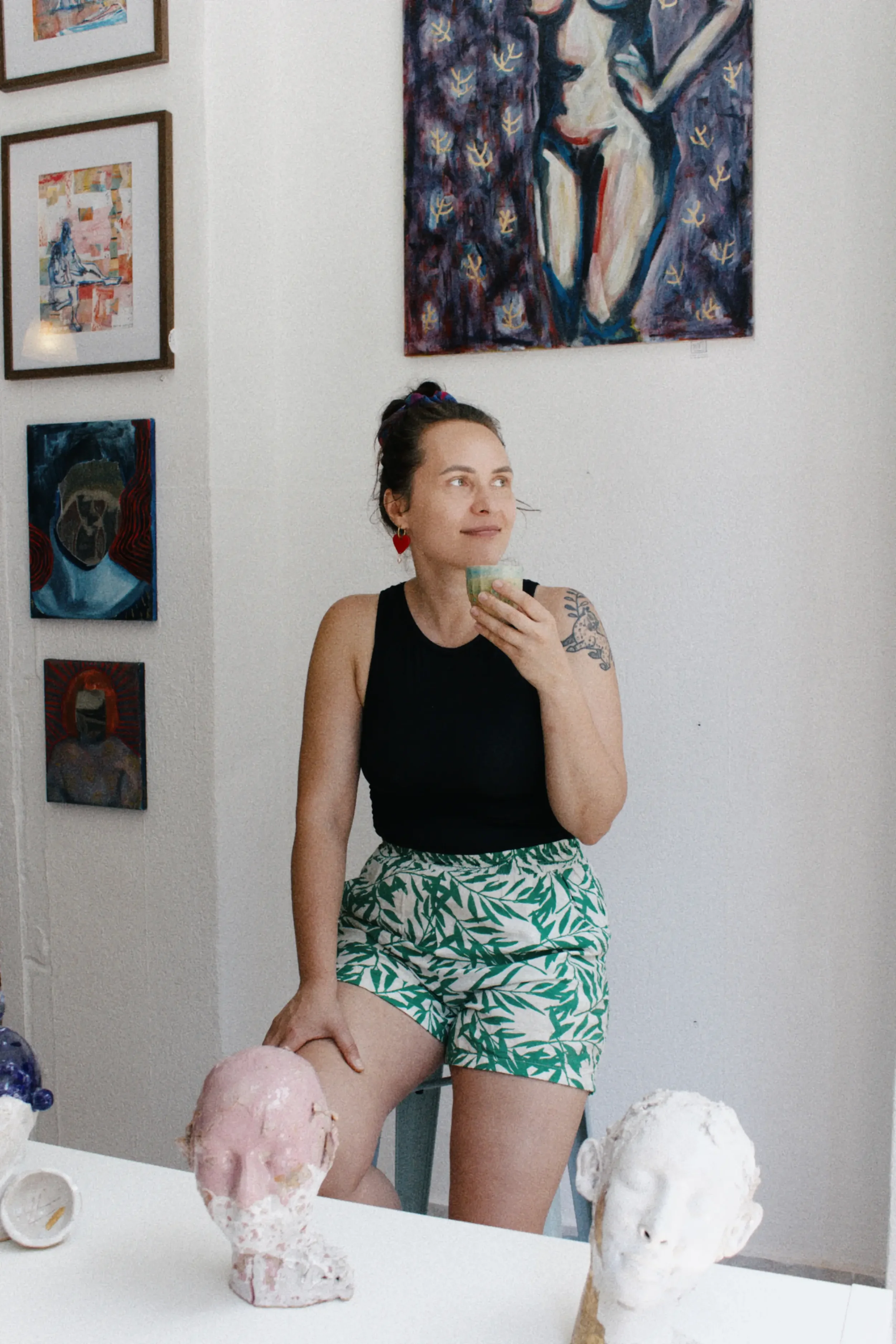Founder of Marti Ceramic Studio standing in her creative studio surrounded by artwork and ceramics