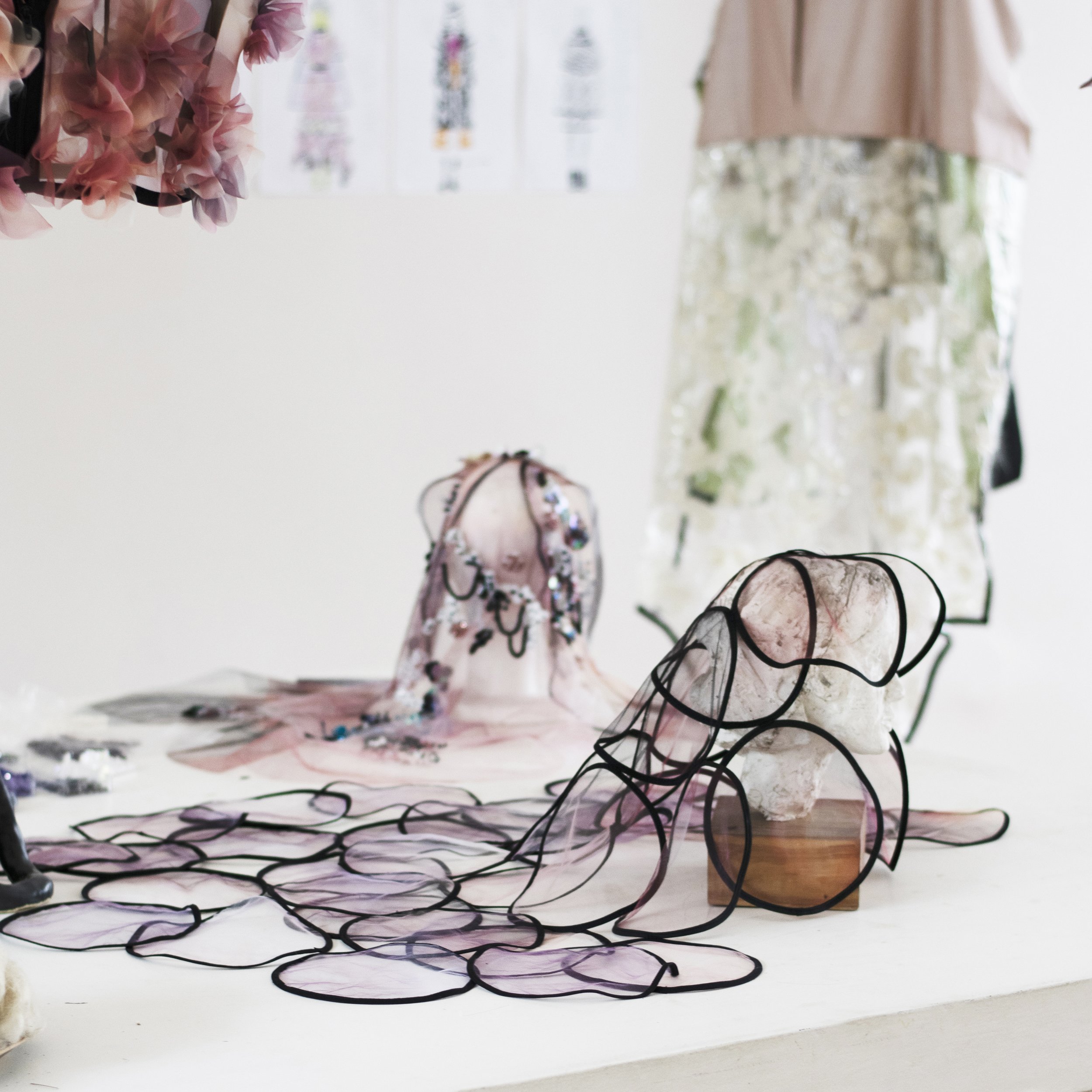 Fashion workspace with fabric scraps and designs