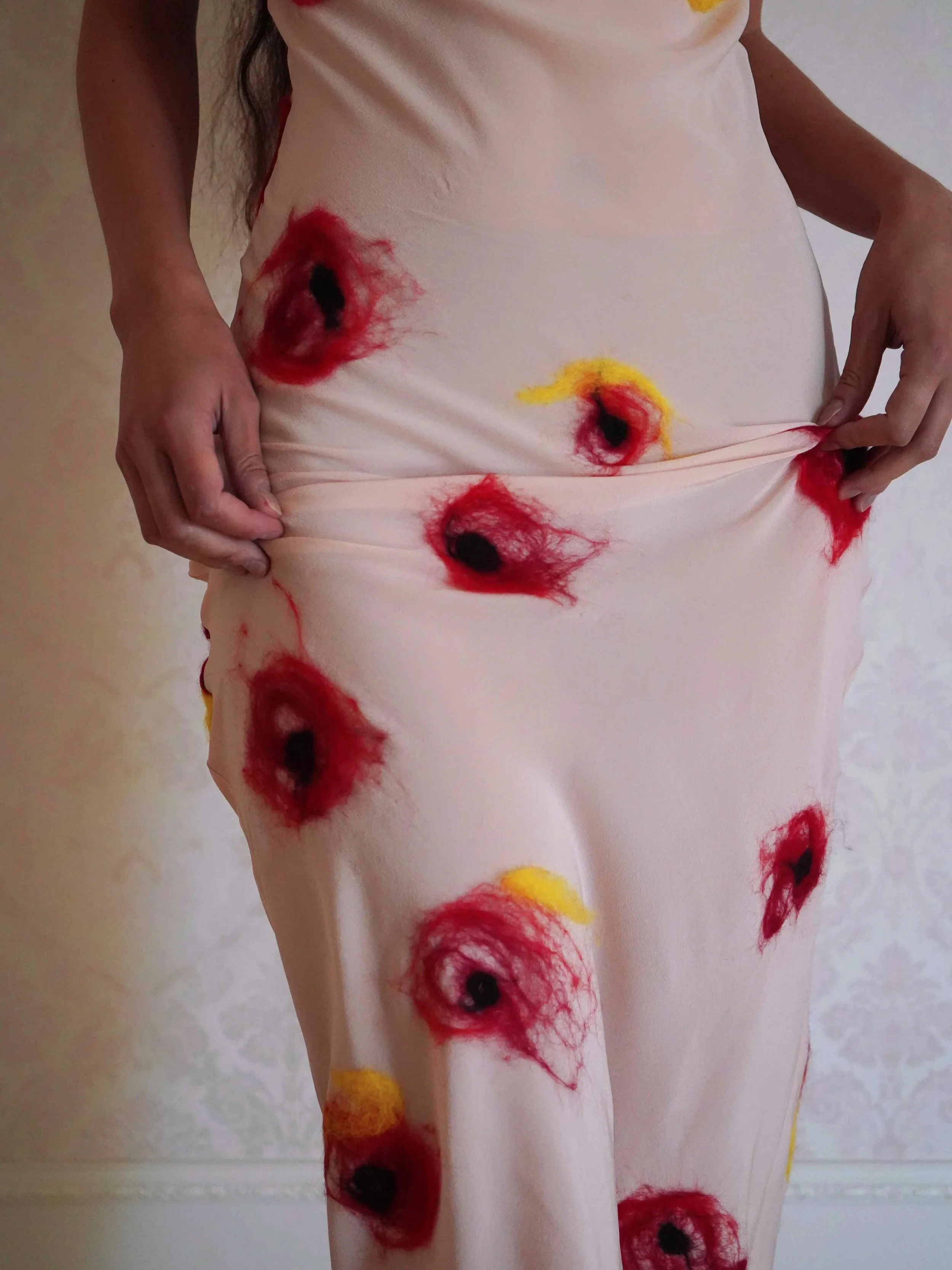 Introducing the Drift Silk Dress

Pale pink silk cr&ecirc;pe, cut on the bias so the fabric falls and drapes closely to the body. Hand-felted in our London studio with fine Italian Merino wool, red, yellow and black floral formations worked by hand, 