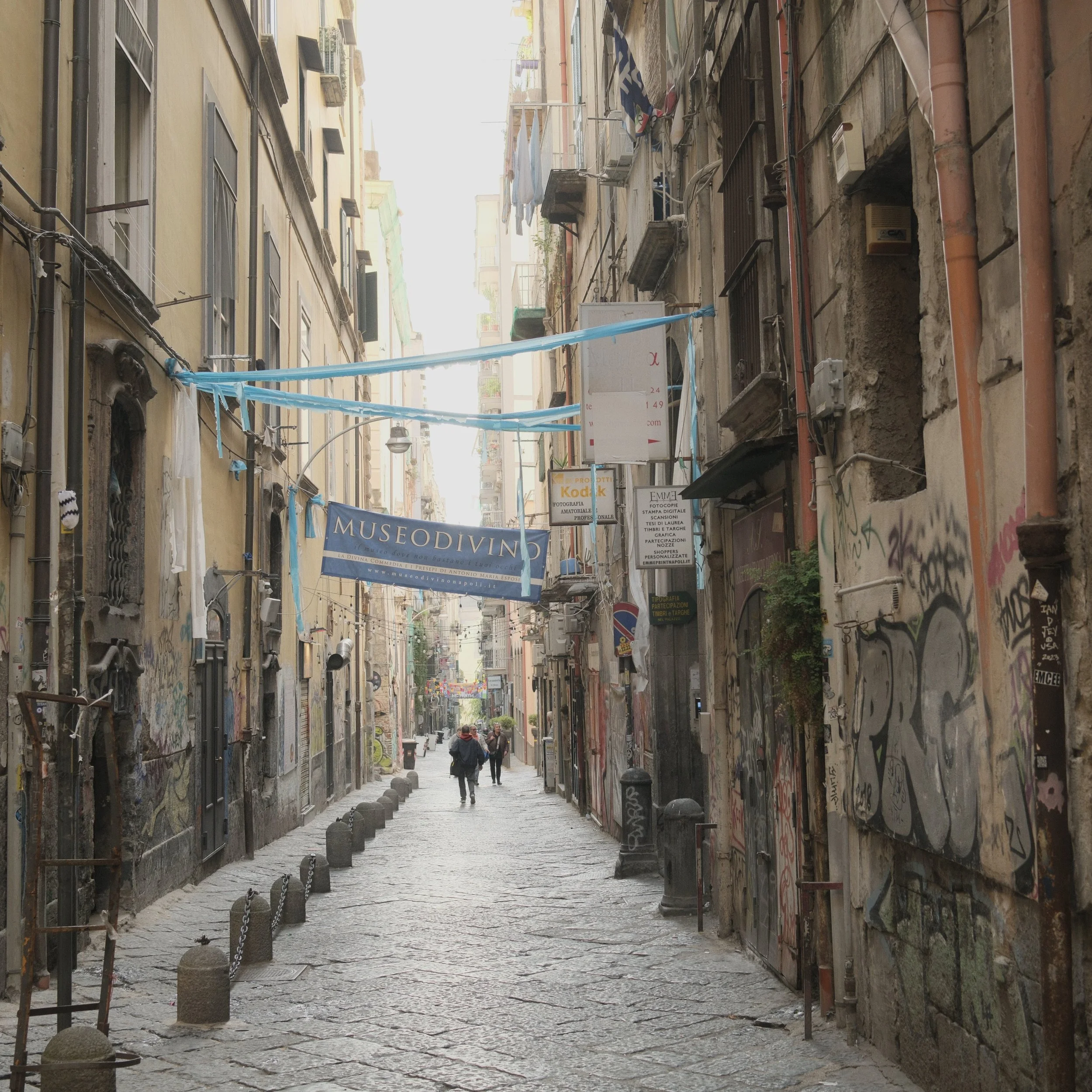 A narrow street in the Spanish Quarter of Naples, with banners in the colours of SSC Napoli.
