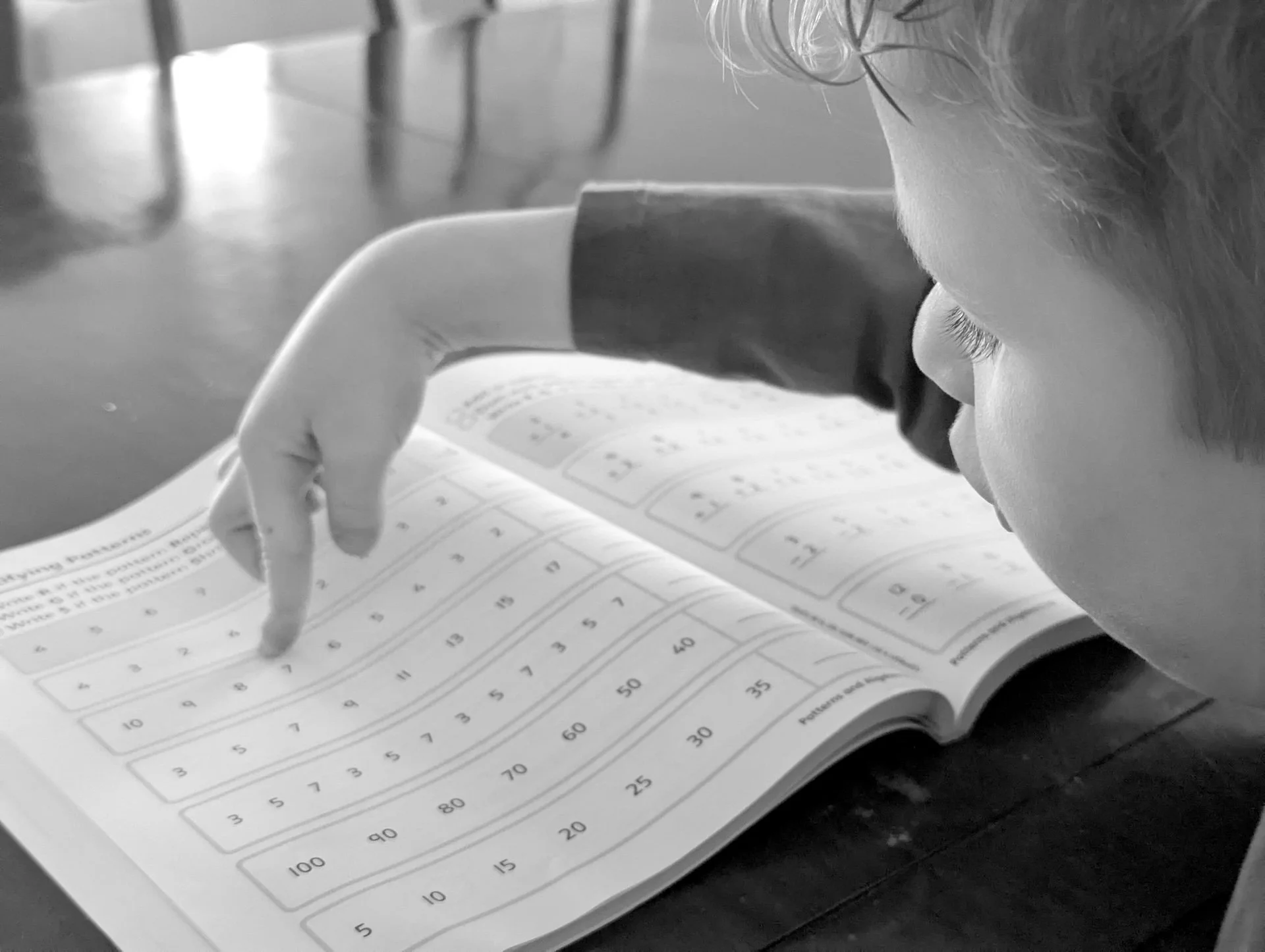 Young student pointing at numbers and math patterns during personalized scaffolded tutoring session for dyscalculia and mathematics support in Halifax