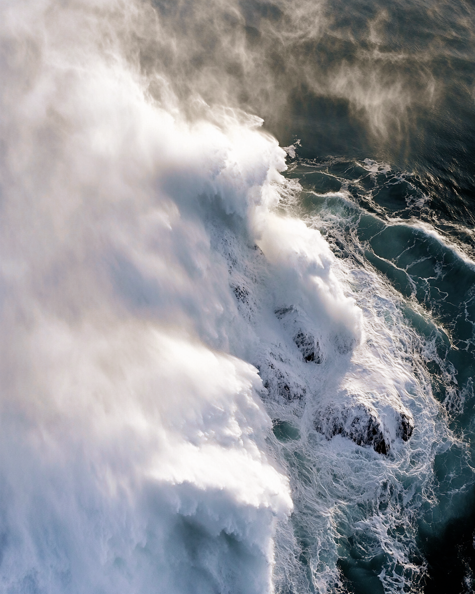 Large ocean waves crashing and spraying water into the air.